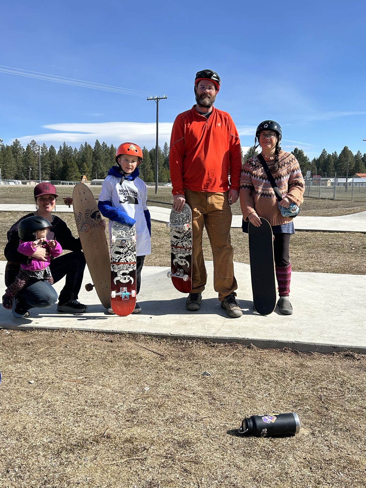 SLSA family with skateboards at the park